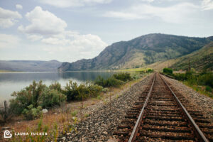 The System represented by train tracks off in the distance lake